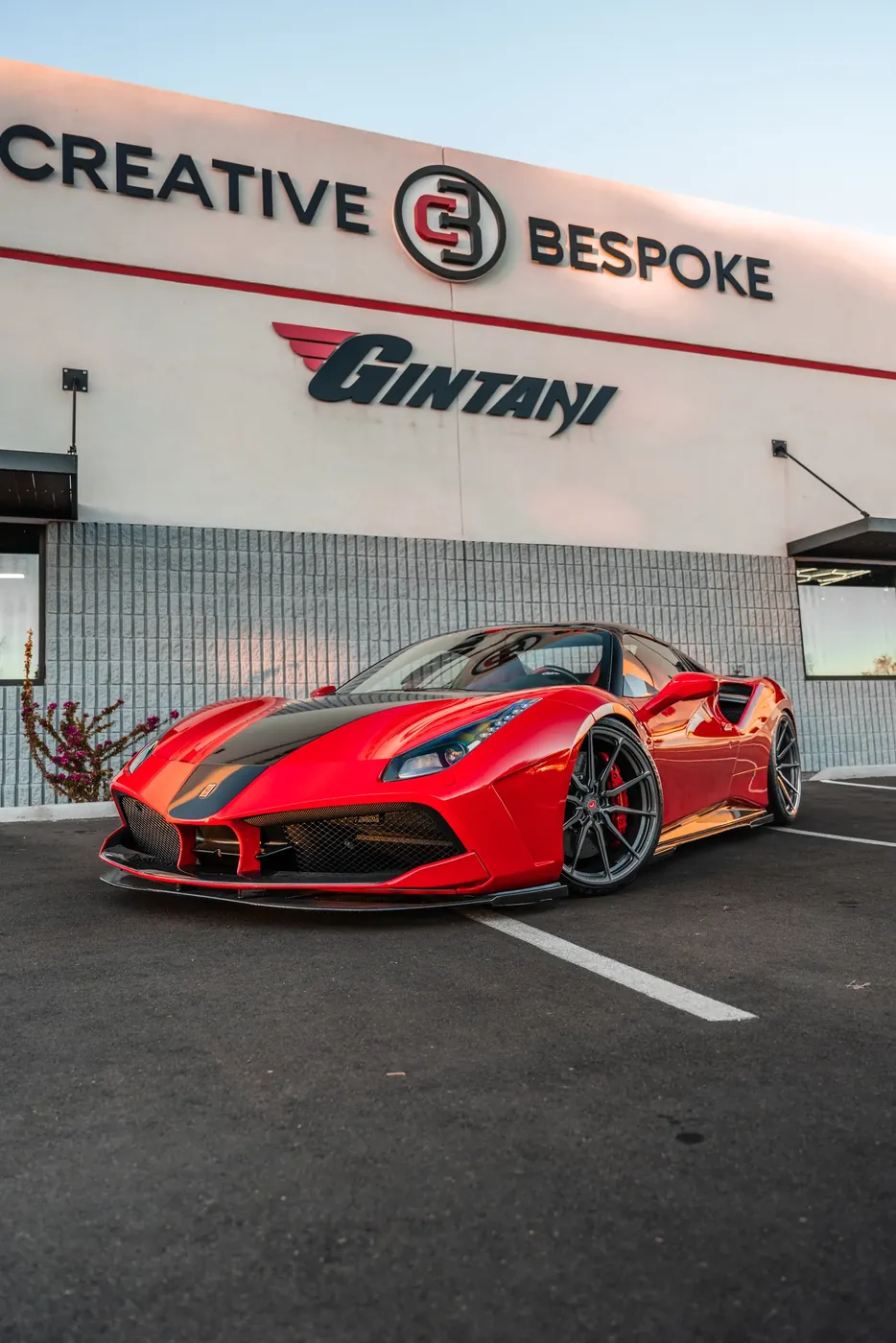 A modified red Ferrari parked outside the Creative Bespoke and Gintani showroom.