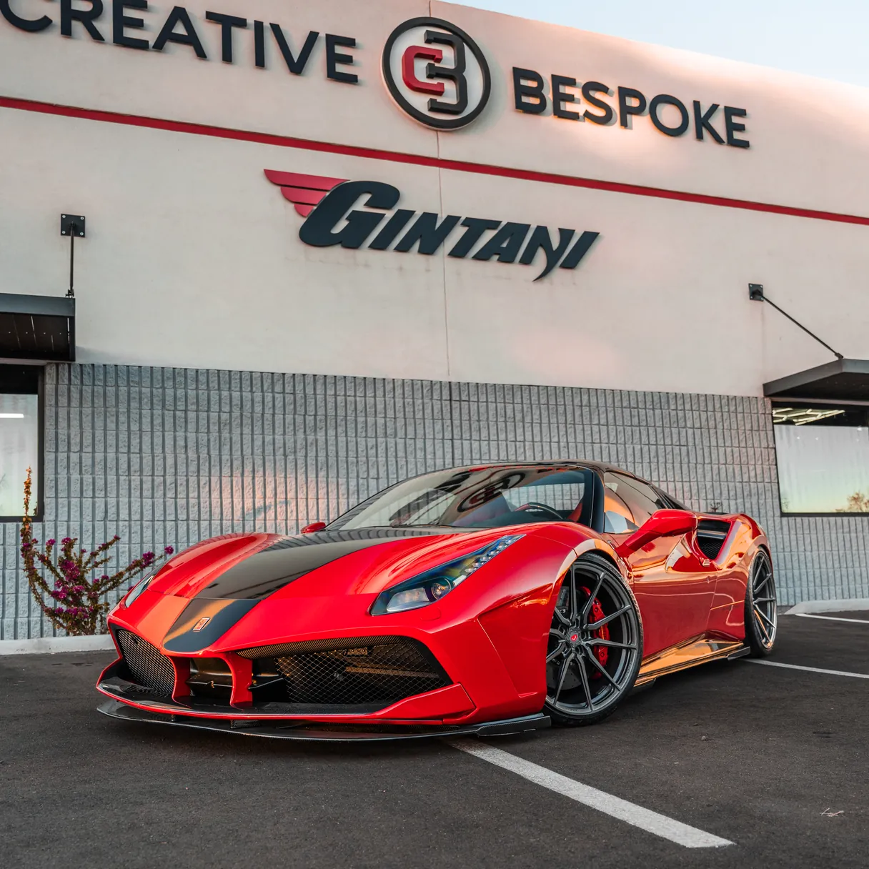 A modified red Ferrari parked outside the Creative Bespoke and Gintani showroom.