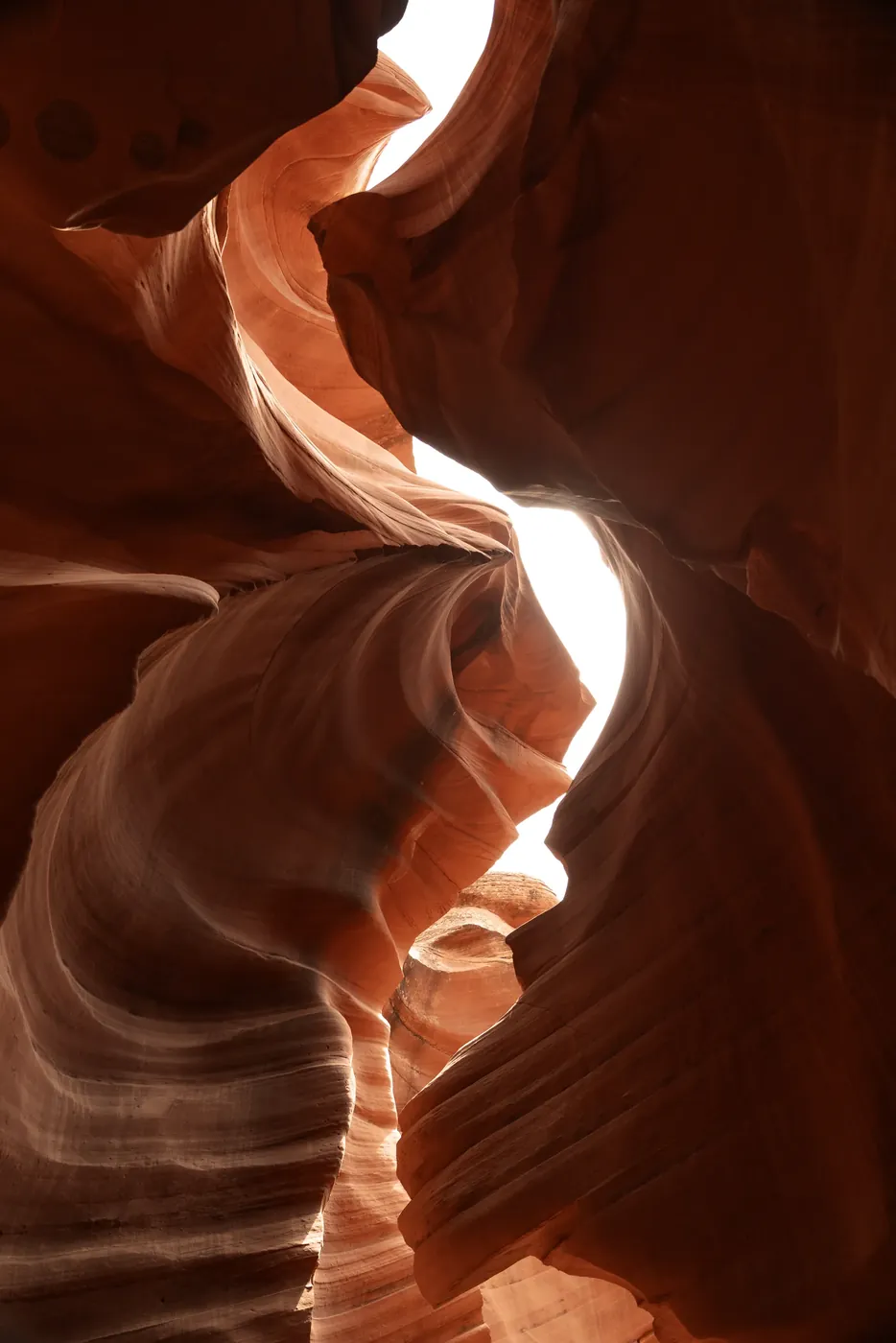 Light falling through the curved sandstone walls of a slot canyon.