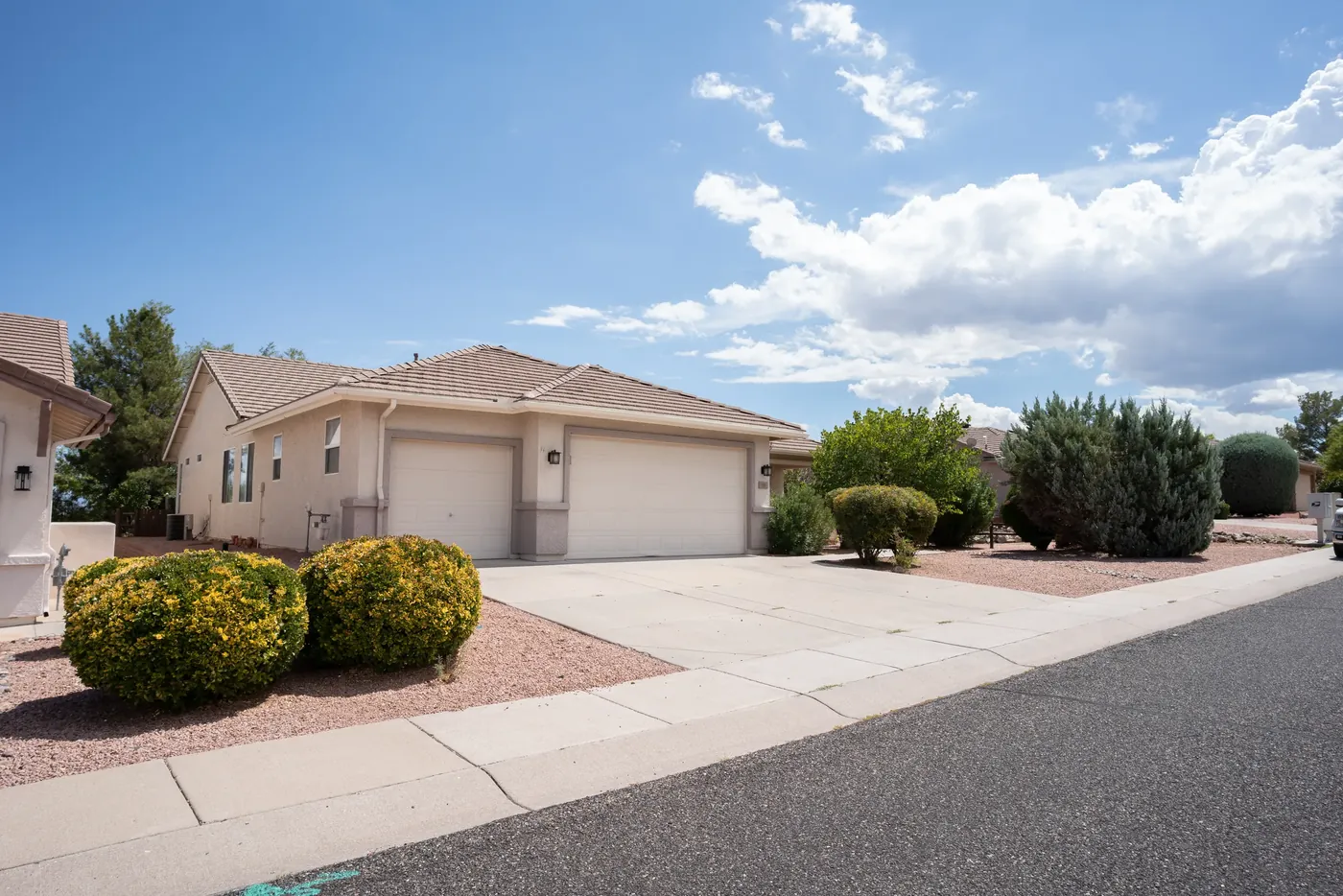 The front elevation and driveway of a single-story suburban home.