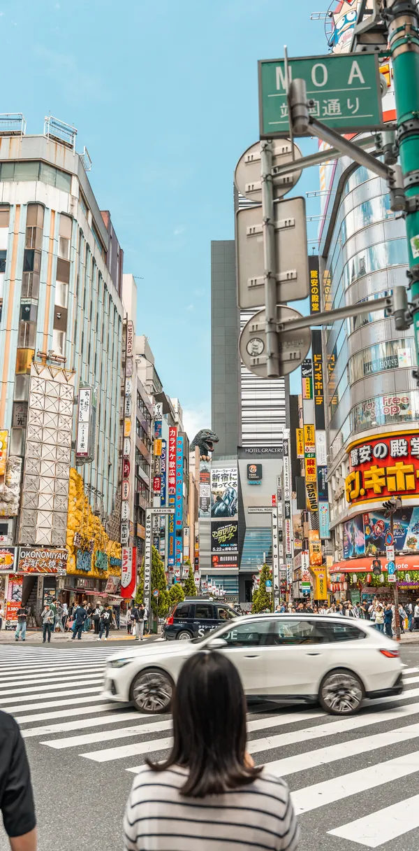 A Tokyo crossing beneath stacked neon signage.